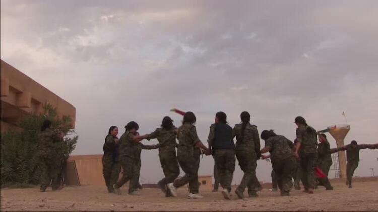 Kurdish People's Protection Unit YPG male and YPJ female fighters dancing traditional Kurdish dance in a military recruitment ceremony in Al Hasakah or Hassakeh district in Syrian Kurdistan commonly known in Kurdish as Rojava North Eastern Syria